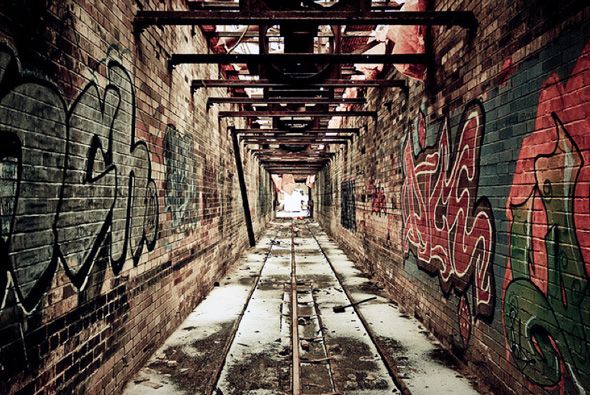 Colorful murals and street art covering the walls of Graffiti Alley, with a mix of vibrant patterns, characters, and urban artwork